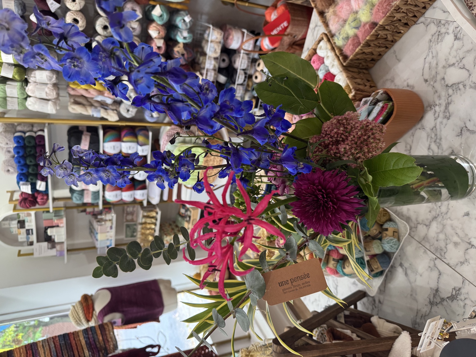 Bouquet of flowers in the Mamou boutique, surrounded by yarn