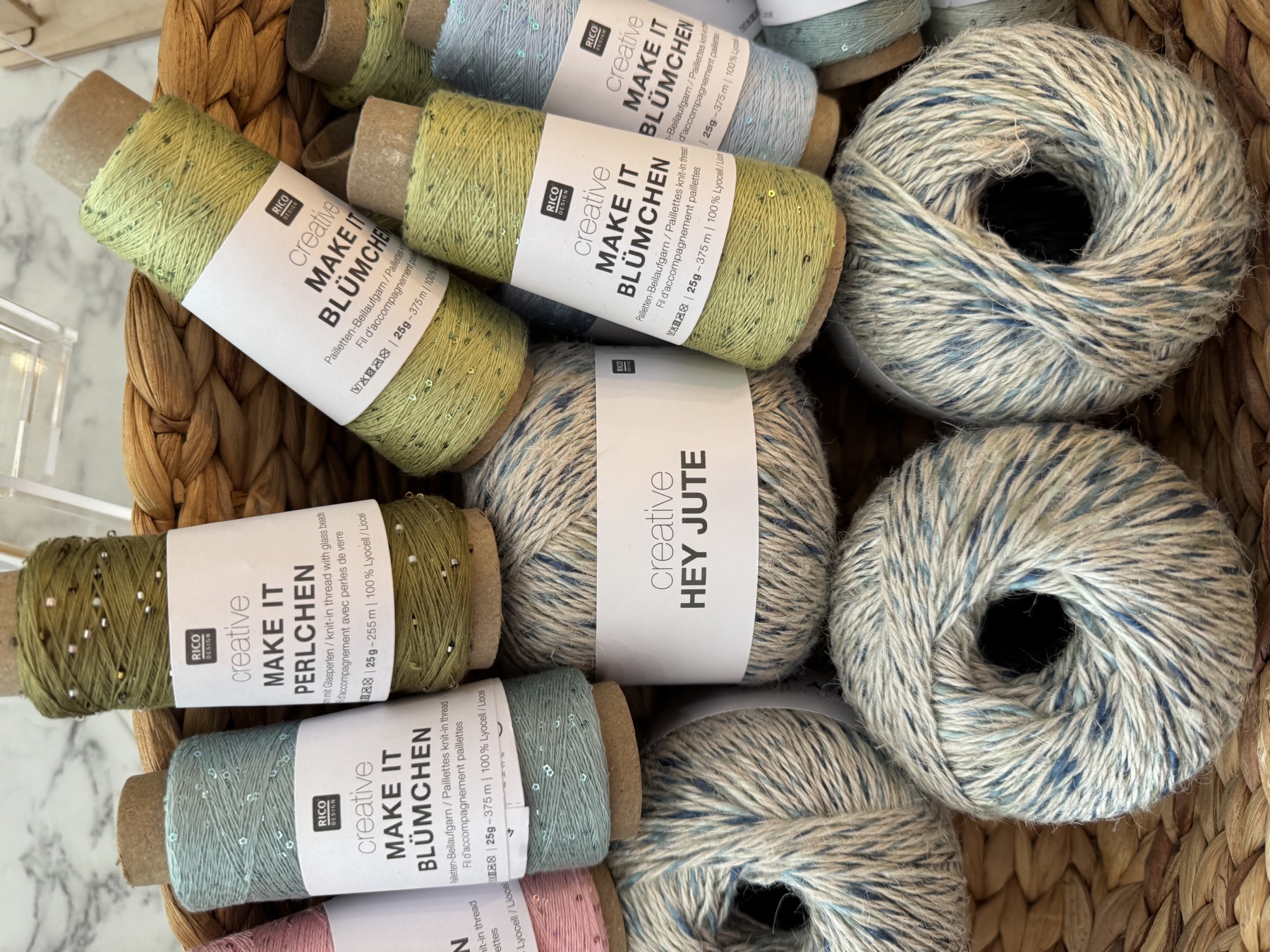 Rico Make It and Hey Jute yarns in a basket